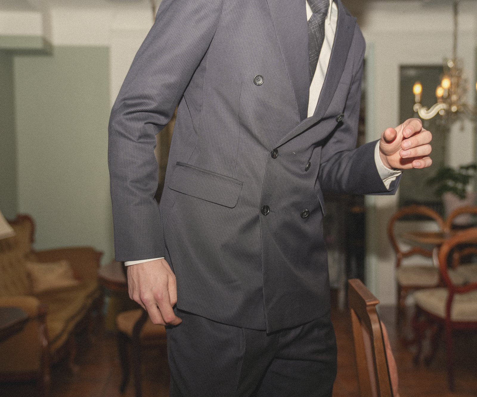 A founder taking a customer's measurements with a tape measure